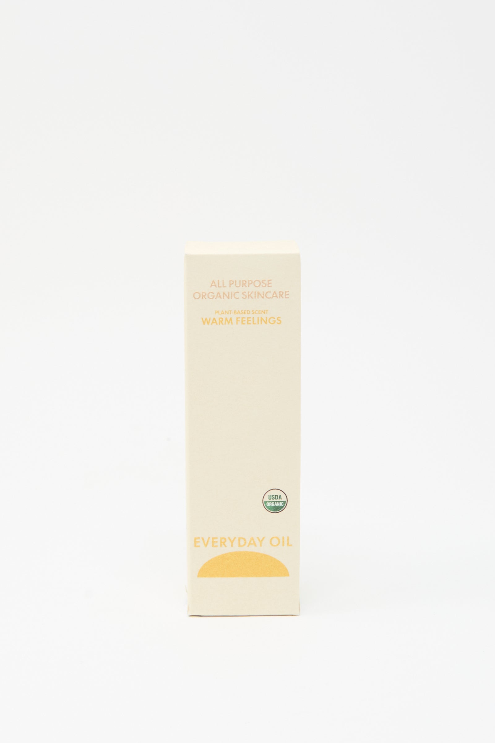 A beige rectangular box labeled "Everyday Oil" with "Warm Feelings - 2 Ounces" and a USDA Organic seal on the front, by Everyday Oil, displays an organic body oil against a plain white background.