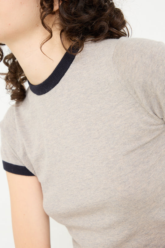 A woman wearing an Extreme Cashmere Cotton Cashmere No. 339 Chloe Tee in Gray/Navy.