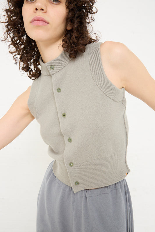 A woman in a grey No. 193 Corset in Bean sweater and skirt by Extreme Cashmere.