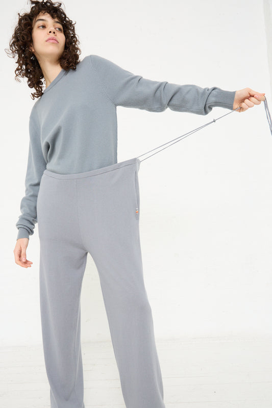 A woman wearing Extreme Cashmere No. 278 Judo Pant in Sage with a drawstring waist.