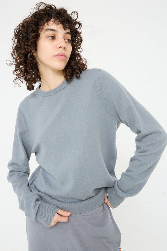 The model is wearing a relaxed fit grey No. 36 Be Classic Sweater in Sage and matching sweatpants from Extreme Cashmere.
