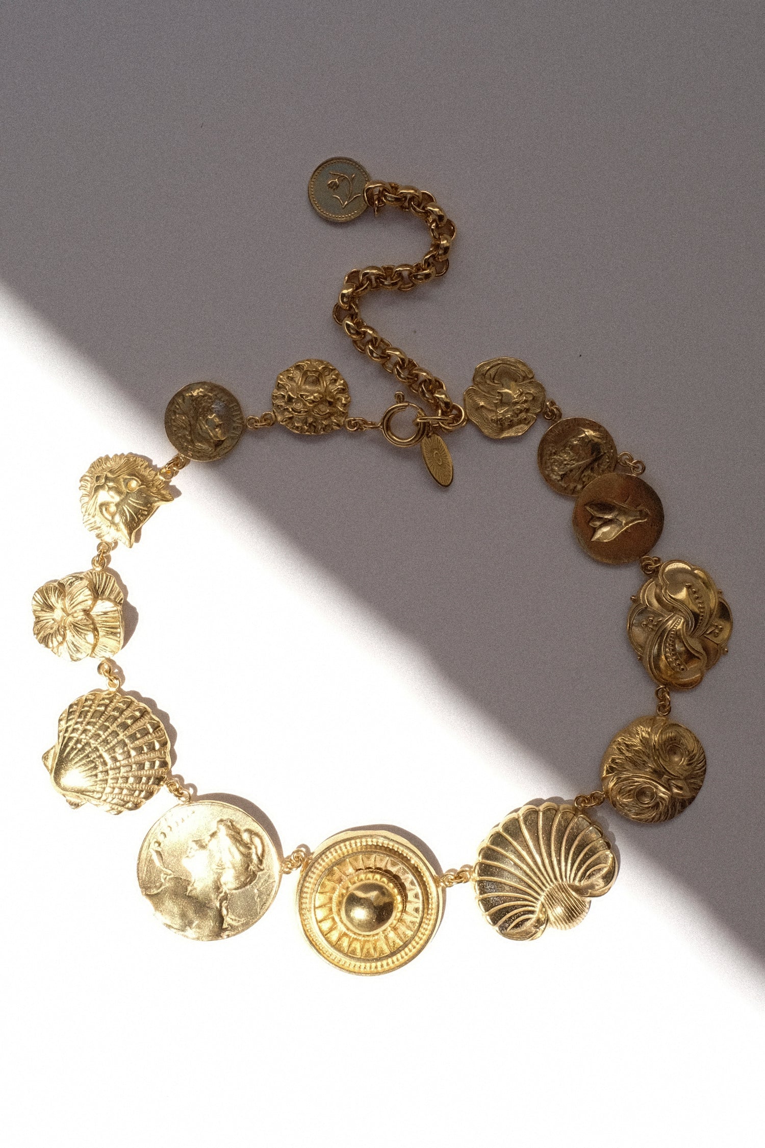 Grianne Morton's Button Necklace in the sun and shade on a white background.