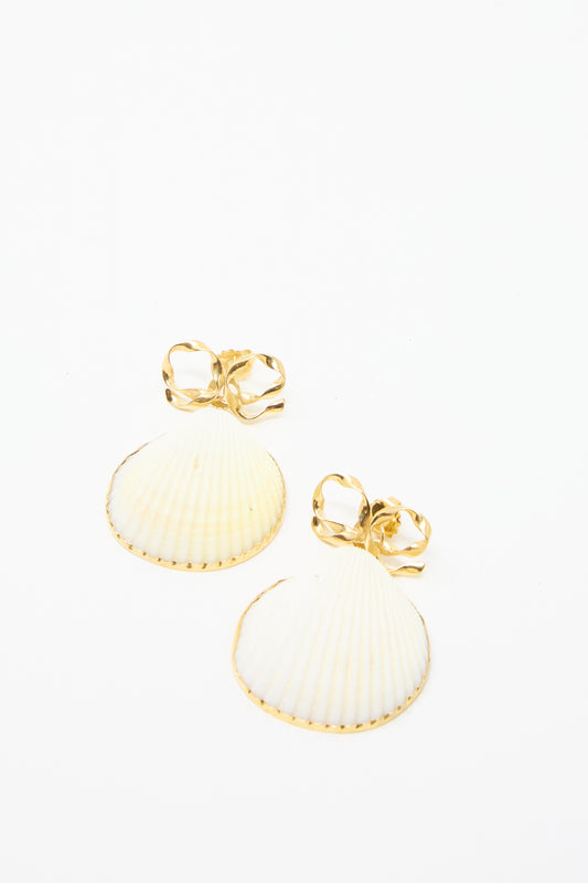 Grainne Morton's Bow and Shell Earrings: 18k gold-plated silver with shell-shaped pendants and decorative bows, set against a white background.