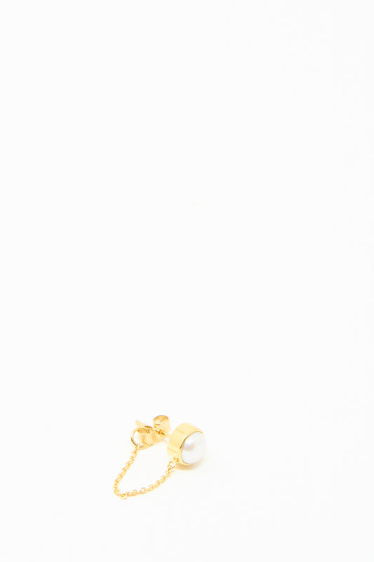 The Grainne Morton Chain Stud Earring showcases a radiant white pearl on 18k gold-plated silver with a short, elegant chain, all set against a pristine white background.