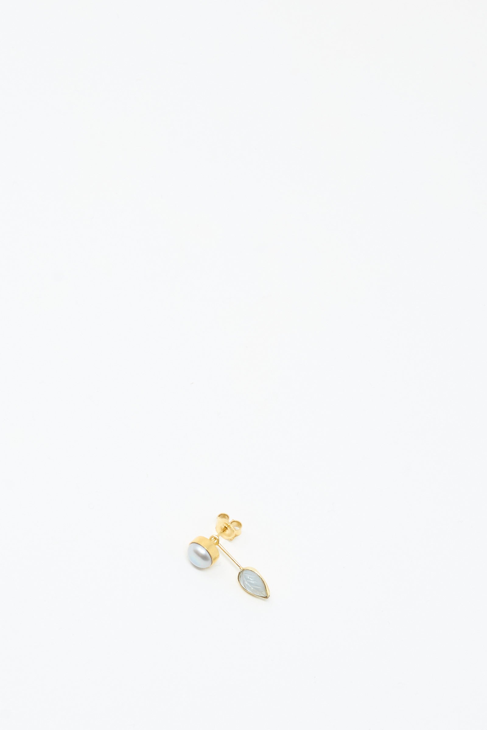 The Grainne Morton Detachable Drop Earring in Pearl and Leaf features a gold pearl stud and a marquise blue stone, both handmade from 18K gold-plated silver, shown on a plain white background.