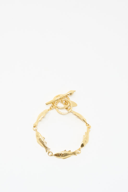 The Grainne Morton Fish Bracelet features gold plated silver fish-shaped links and a toggle clasp, handmade in Edinburgh. Displayed on a plain white background.