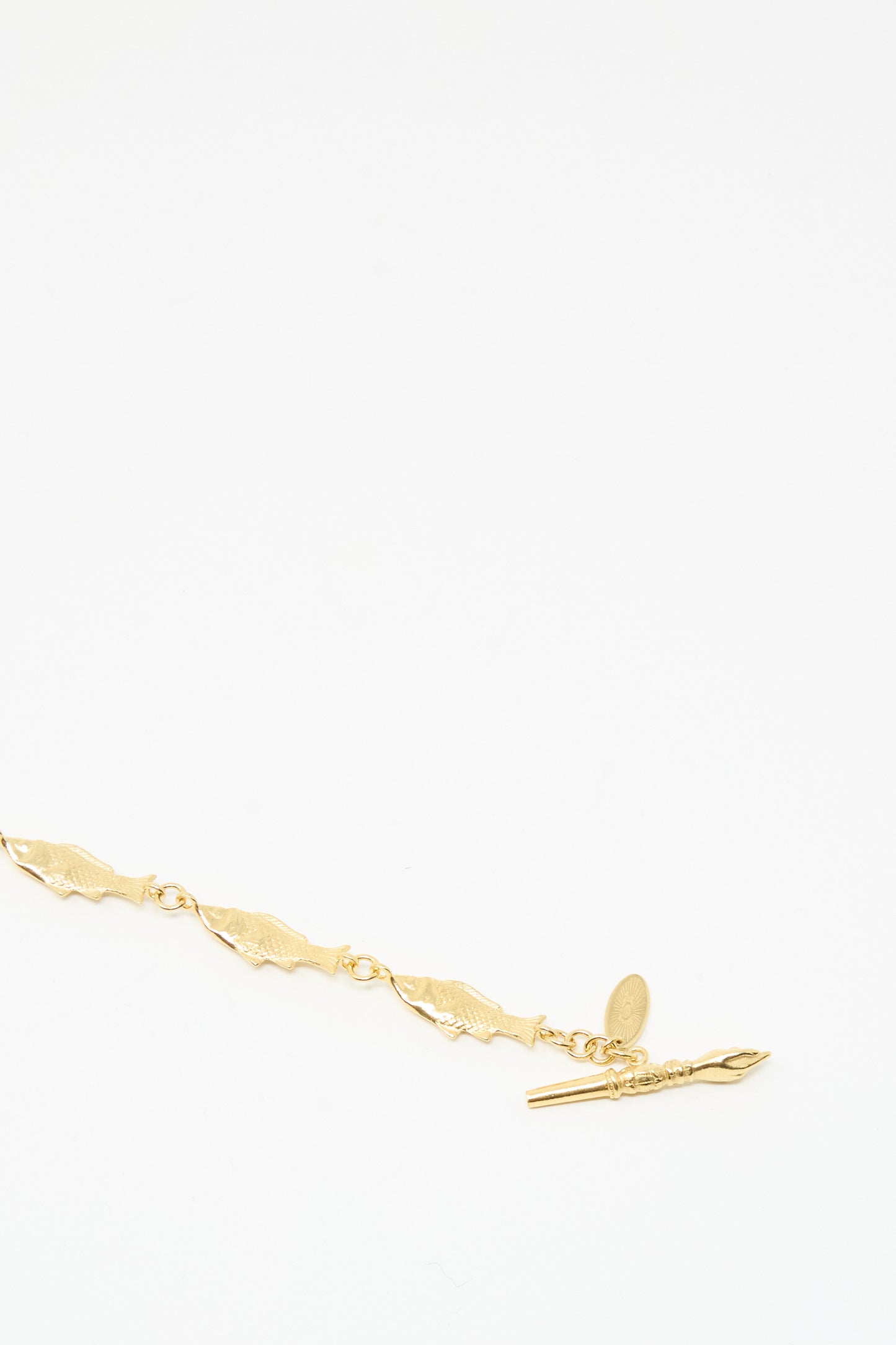 The Grainne Morton Fish Bracelet is a gold-plated silver chain with leaf-shaped links and a toggle clasp, handmade in Edinburgh and shown on a plain white background.
