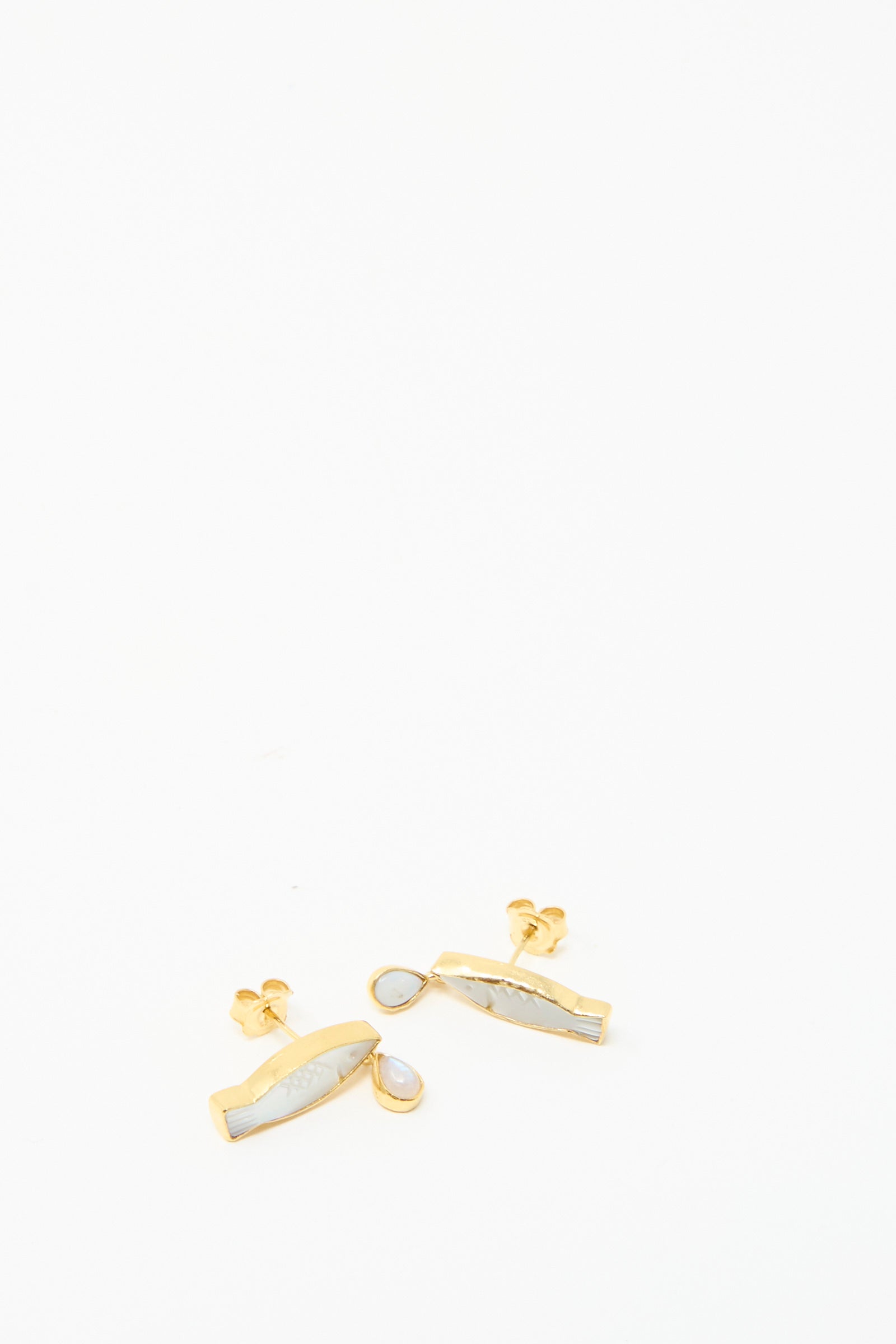 Grainne Morton's Fish Drop Earrings feature fish shapes and small white stones, made from gold-plated silver, presented on a plain white background.