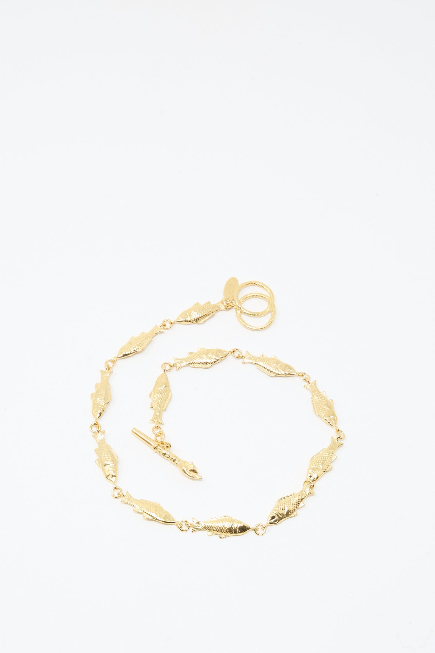 A Fish Necklace by Grainne Morton, featuring gold-plated silver with leaf-shaped links and a toggle clasp, handmade in Edinburgh and shown on a plain white background.