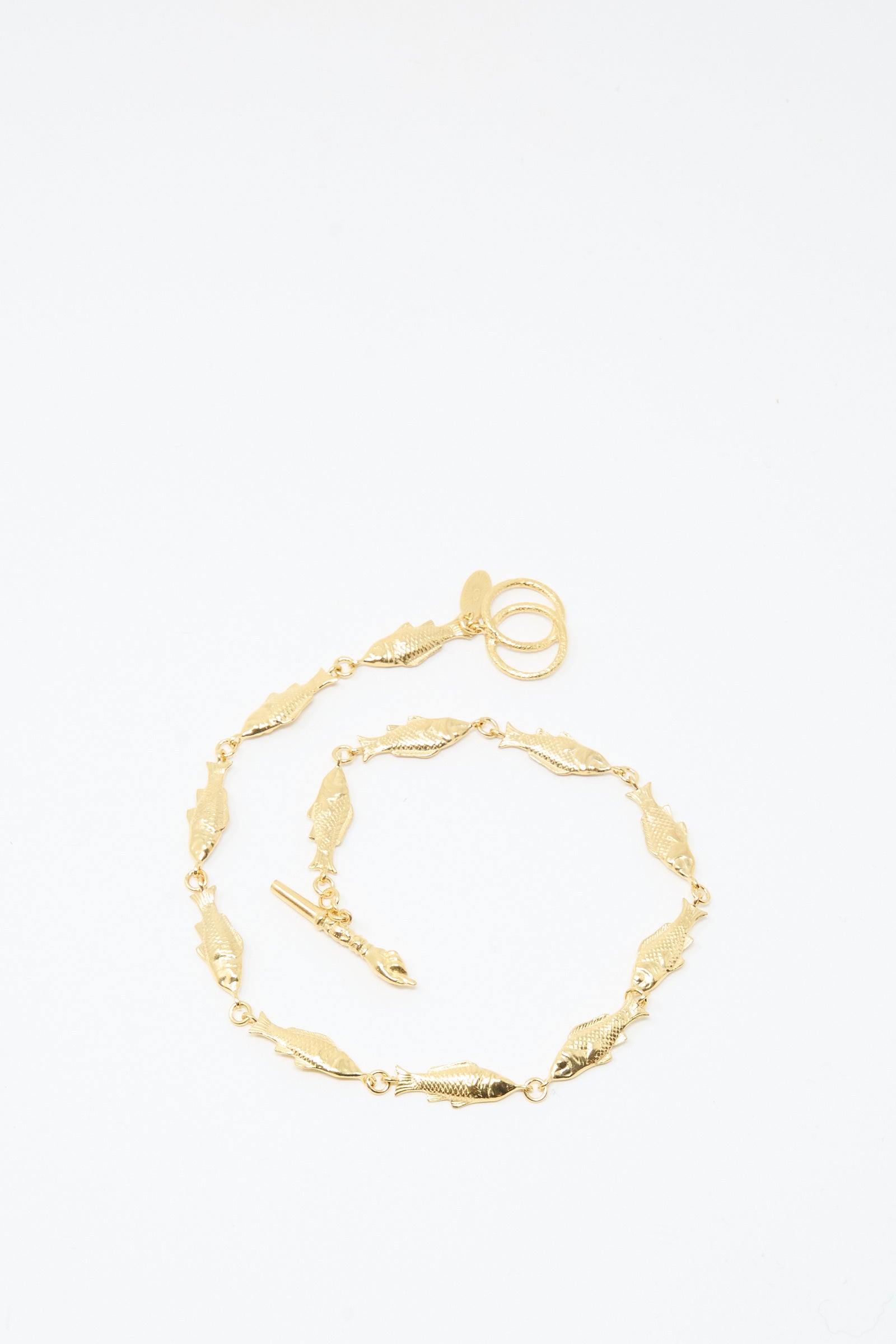 A Fish Necklace by Grainne Morton, featuring gold-plated silver with leaf-shaped links and a toggle clasp, handmade in Edinburgh and shown on a plain white background.