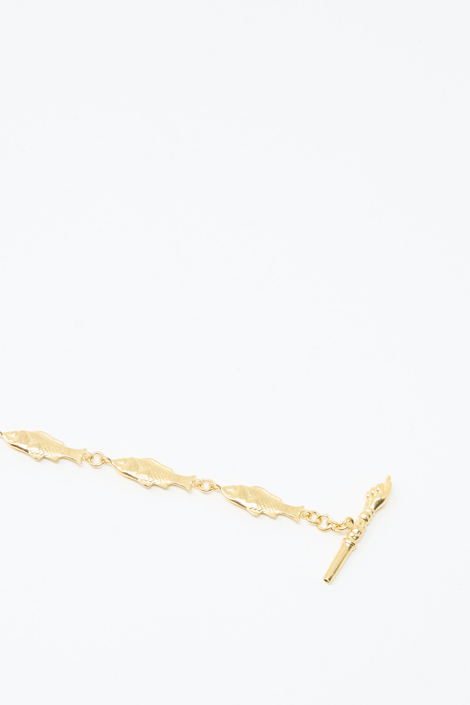 A Fish Necklace by Grainne Morton, featuring gold-plated silver and a bar-and-toggle clasp, handmade in Edinburgh and displayed on a plain white background.