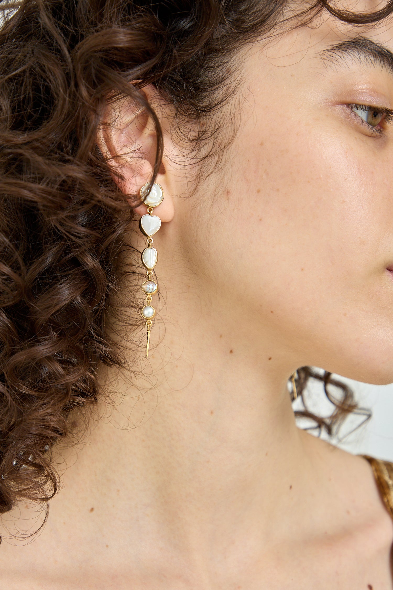 The model is wearing a pair of Five Charm with Victorian Drop Earrings from Grainne Morton.