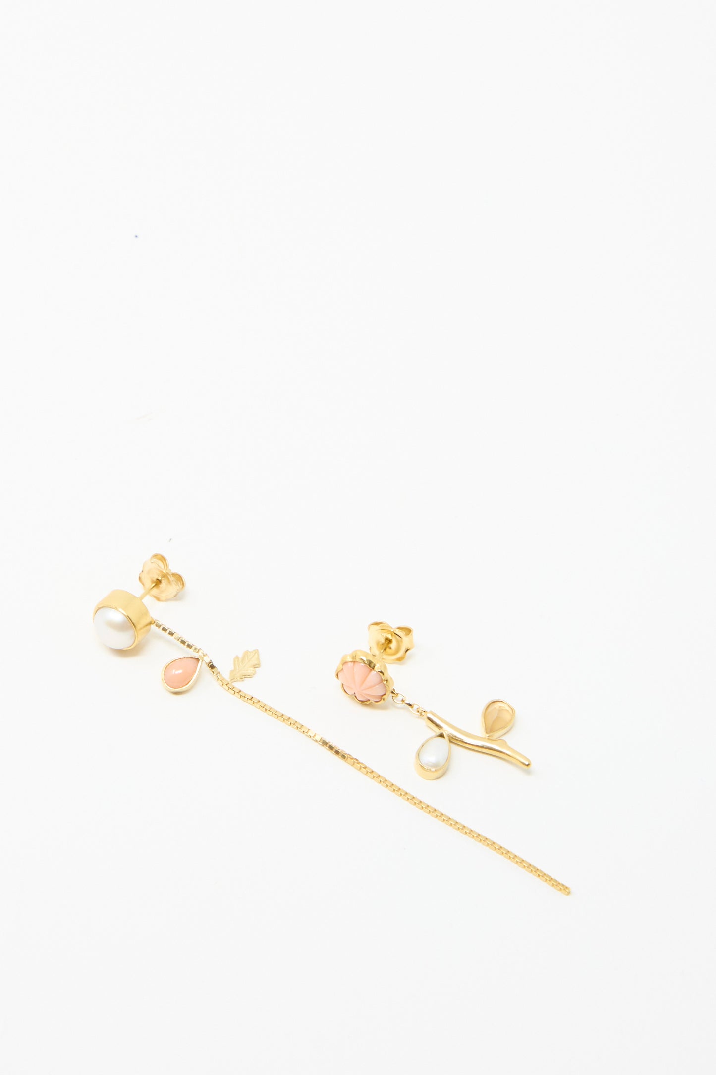 Grainne Morton's Flower Stem and Chain Detachable Drop Earrings feature asymmetrical 18k gold-plated silver adorned with pearls and coral; one has a pearl chain drop, while the other features a charming coral flower stem.