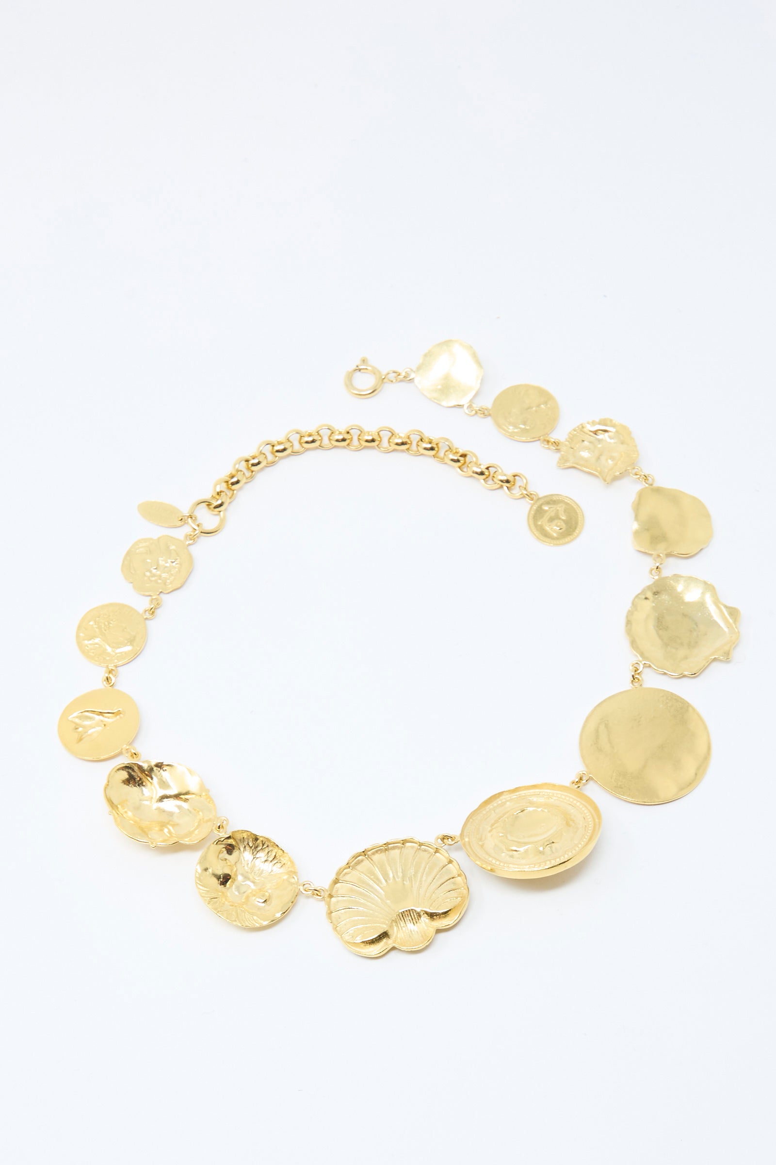 The Gold Button Necklace by Grainne Morton is a gold-plated silver piece featuring textured, irregular circular pendants in a semi-circle on a chunky belcher chain.