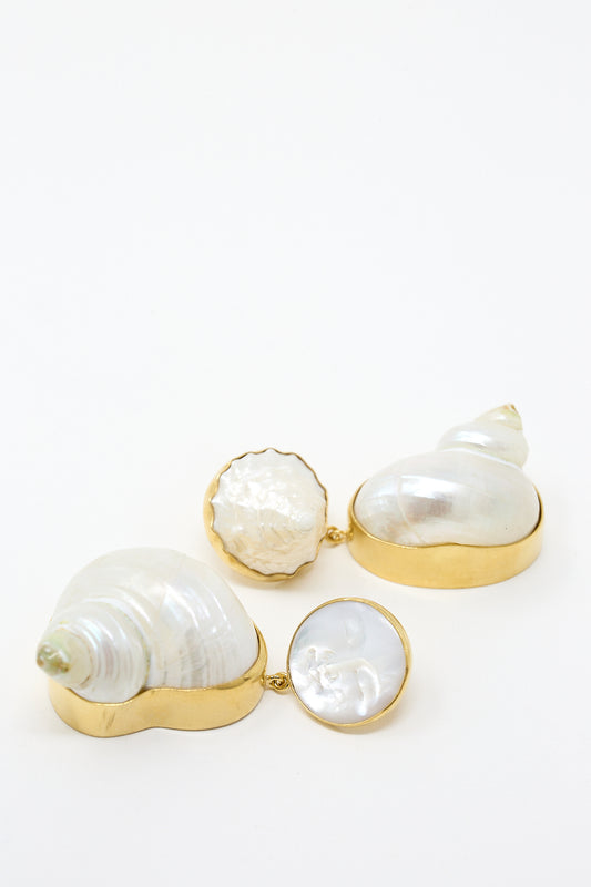 Two Moon and Star Shell Drop Earrings, 18K gold-plated silver shells on a white surface by Grainne Morton.