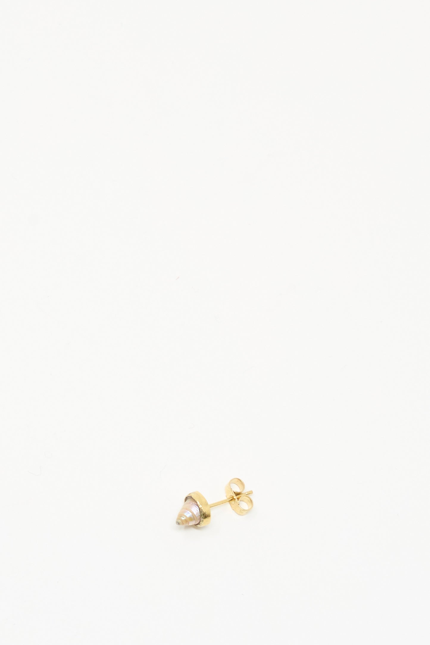 The Grainne Morton Stud Earring in Shell, crafted with ethically sourced materials, sits at the bottom center of a white background.
