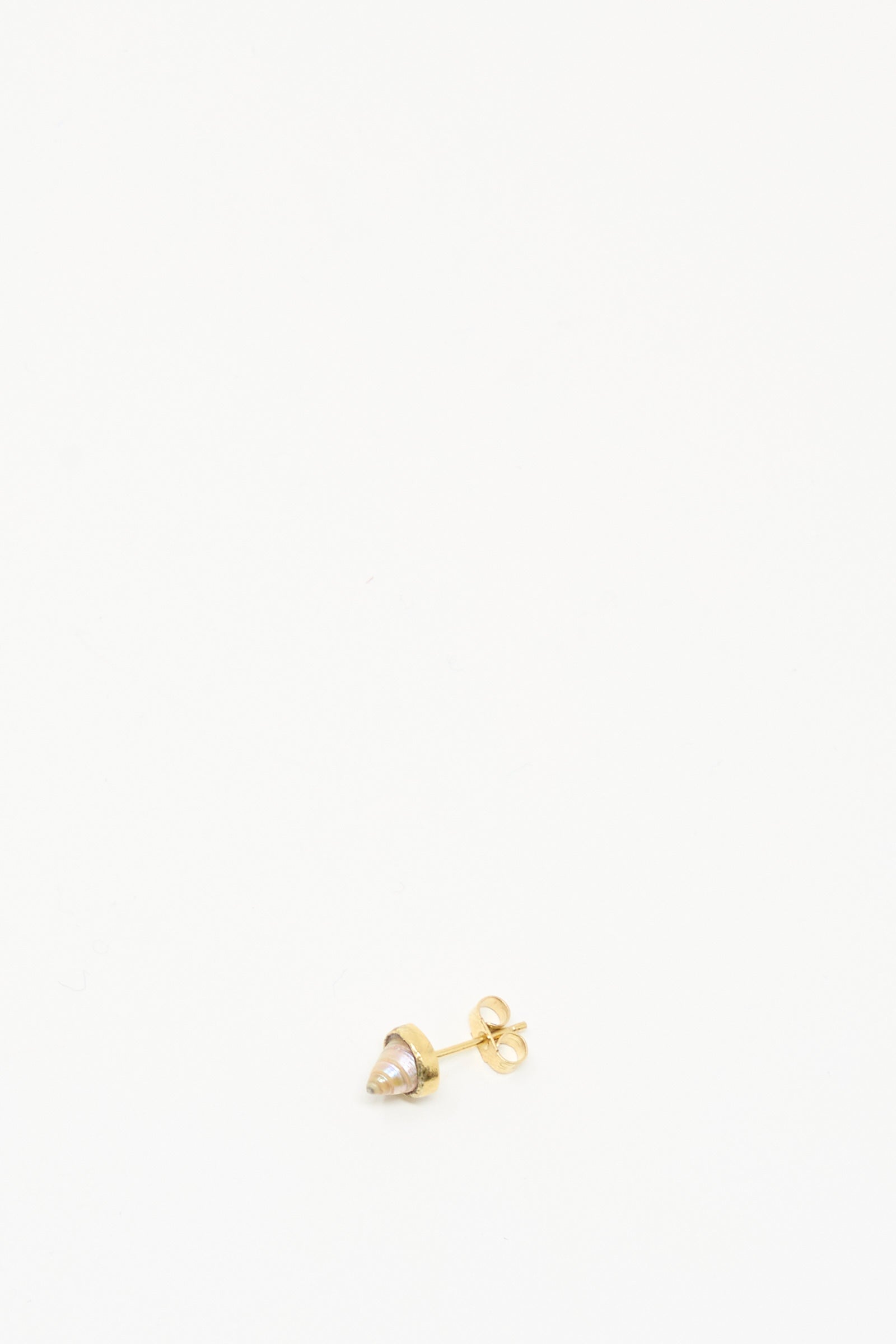 The Grainne Morton Stud Earring in Shell, crafted with ethically sourced materials, sits at the bottom center of a white background.