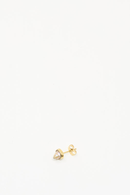 The Grainne Morton Stud Earring in Shell, crafted with ethically sourced materials, sits at the bottom center of a white background, showcasing its refined simplicity.