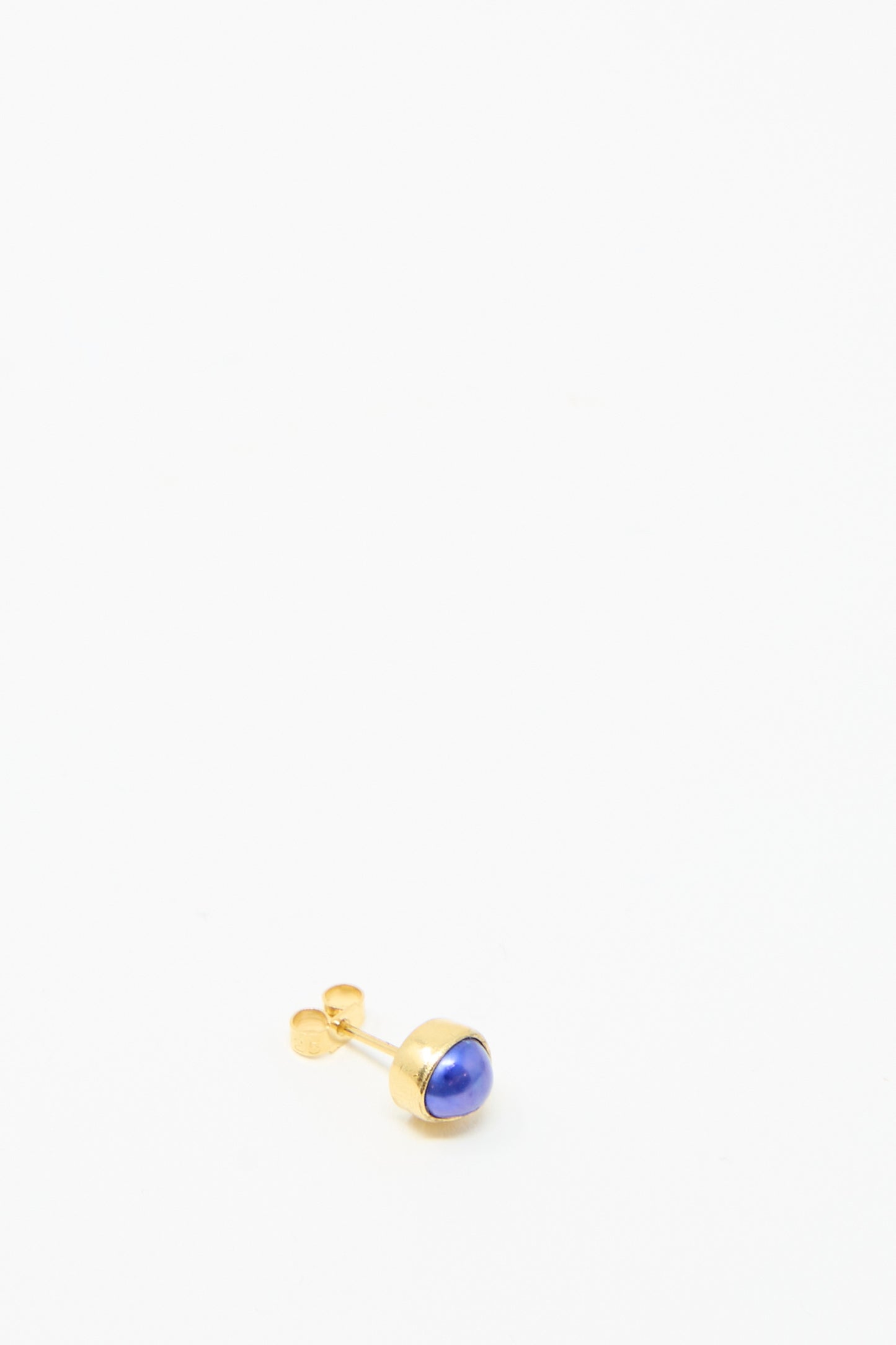 The Grainne Morton Stud Earring in Blue Pearl,  set on a white background, is made  from 18k gold-plated silver with a blue stone. 