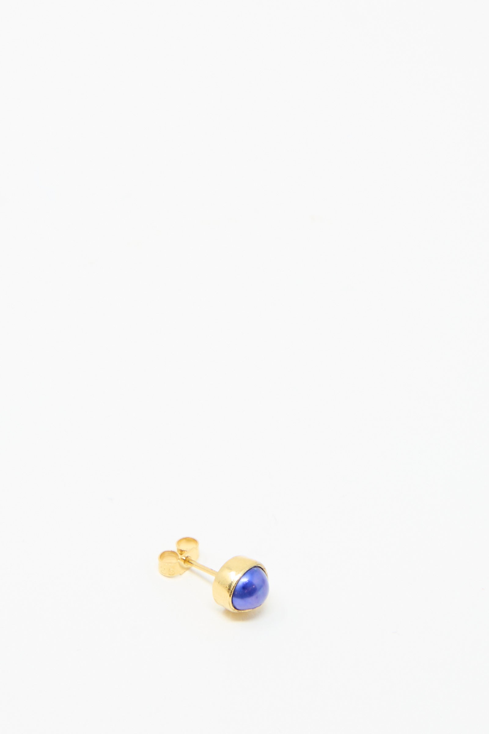 The Grainne Morton Stud Earring in Blue Pearl,  set on a white background, is made  from 18k gold-plated silver with a blue stone. 