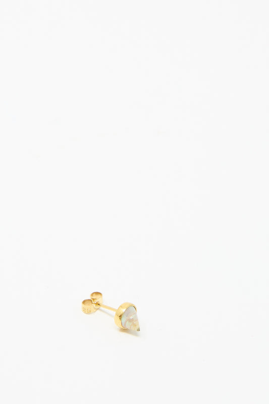 The Stud Earring in Shell by Grainne Morton is made rom ethically sourced materials, highlighting a small conical gemstone tip set in 18k gold-plated silver against a plain white background.