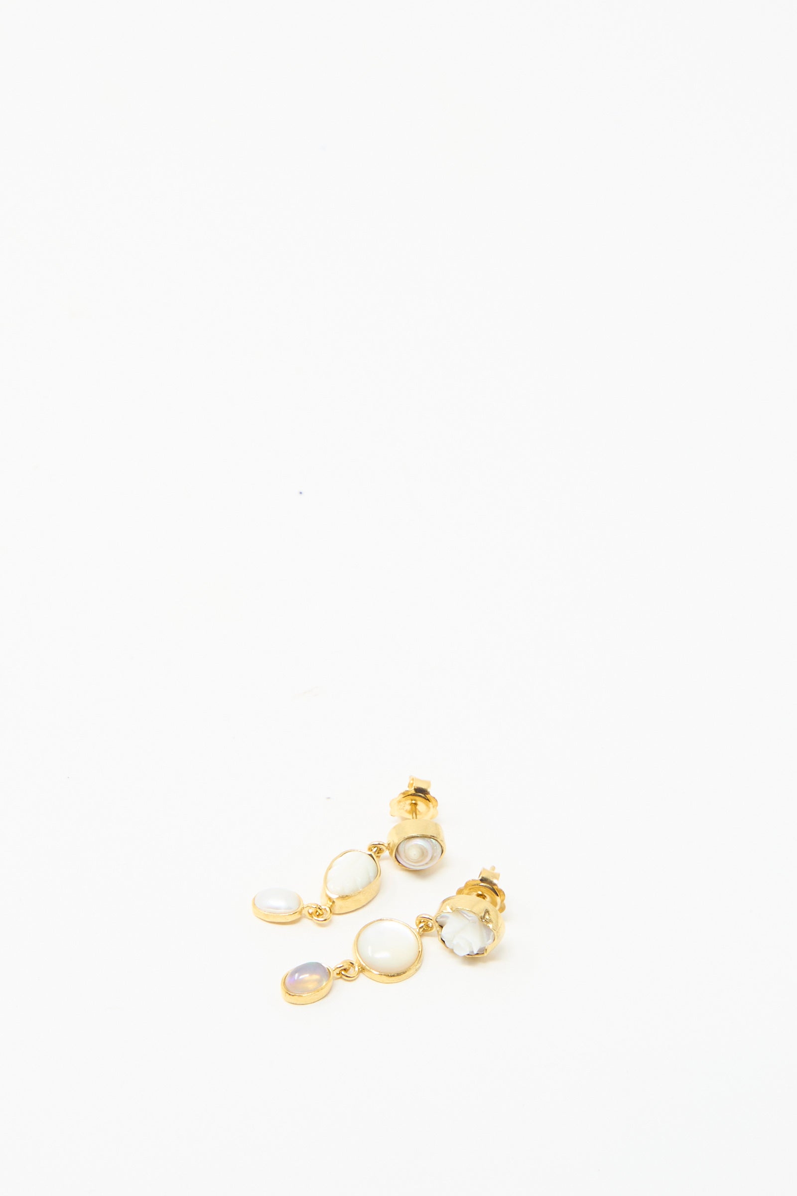 Grainne Morton's Three Charm Moving Drop Earrings are 18k gold-plated and feature iridescent charms with multiple white and lavender stones on a plain white background.