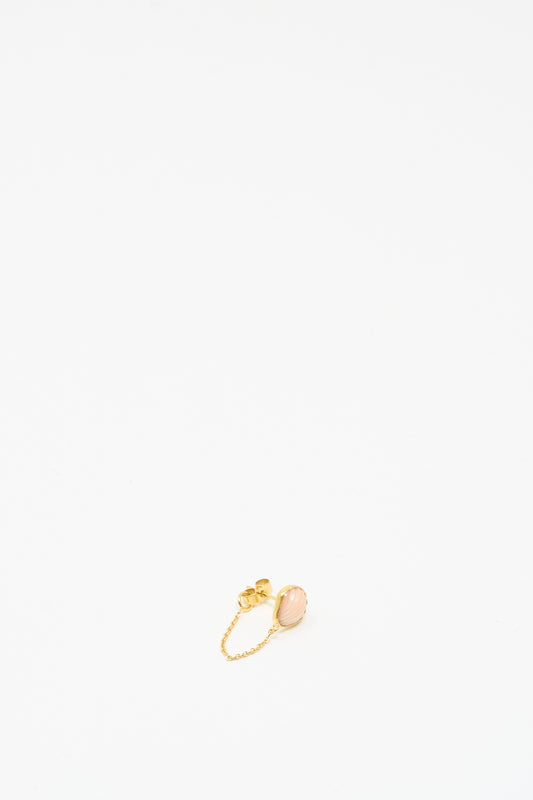 The Grainne Morton Chain Stud Earring in Pink Shell, a small 18K gold plated silver piece, is centered near the bottom of a plain white background.