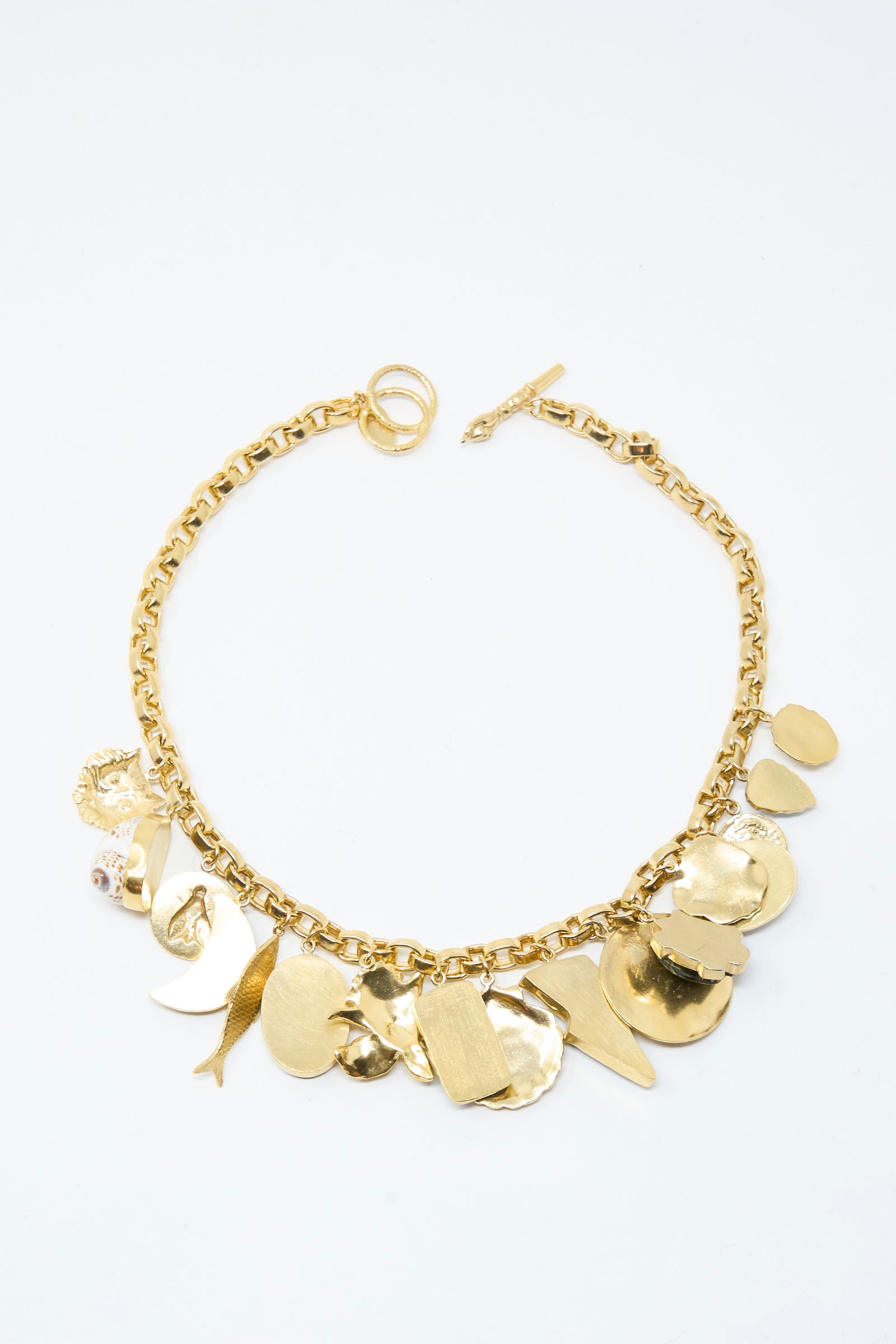 The Chunky Charm Necklace by Grainne Morton is handmade in Edinburgh with 18k gold plated silver and features assorted textured, irregularly shaped gold charms.
