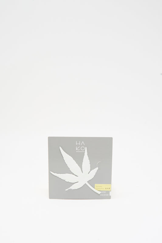 A square, grey Morihata Paper Leaf Autumn Incense in Osmanthus shaped like a maple leaf.