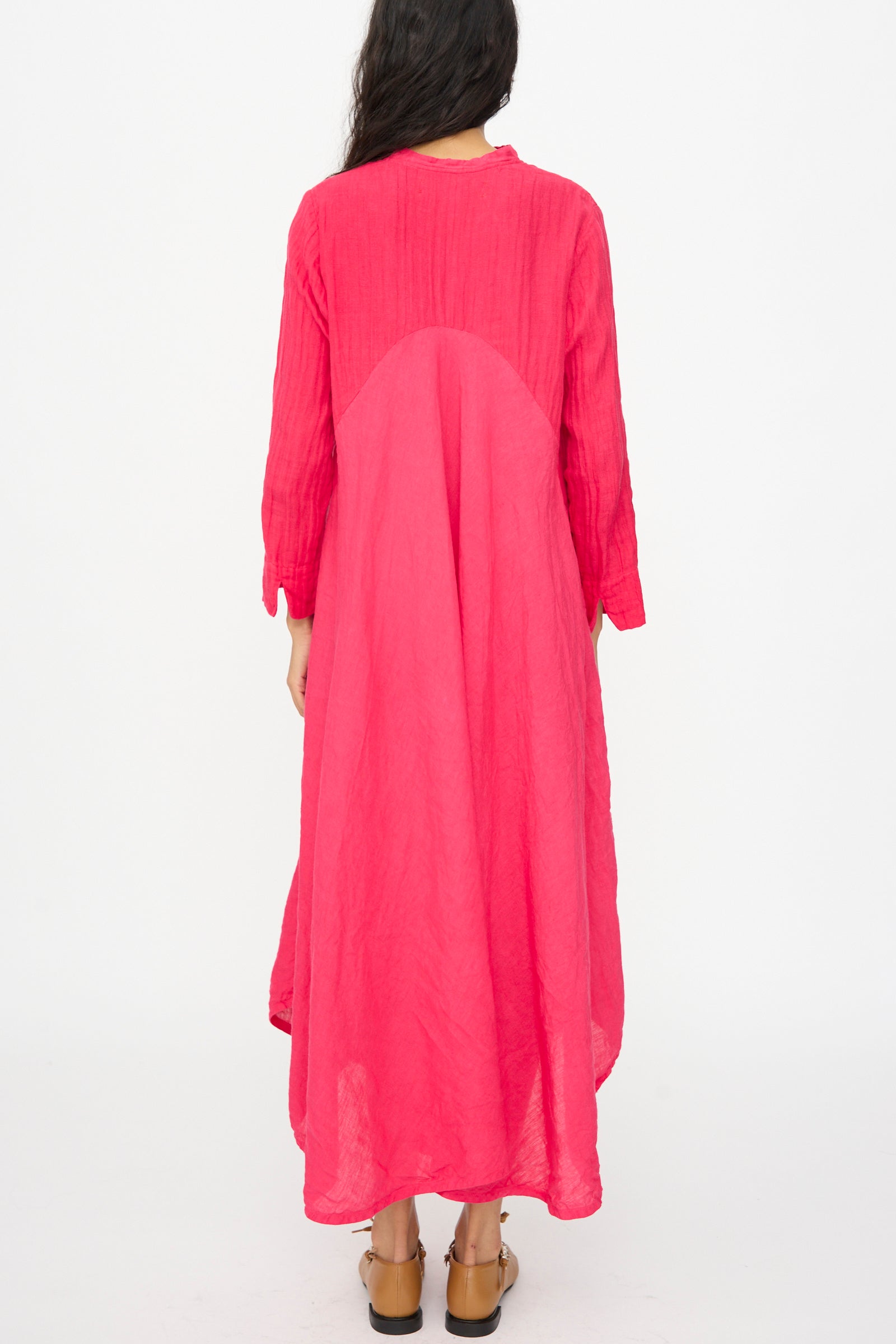 A woman stands facing away, wearing the Hallelujah Cotton Linen Robe de Femme de Chambre in Cherry Red with brown sandals, set against a plain white background.