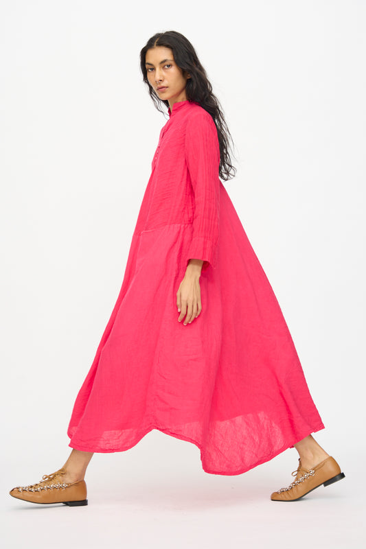 A person wearing the Hallelujah Cotton Linen Robe de Femme de Chambre in cherry red and tan flat shoes walks against a plain white background.