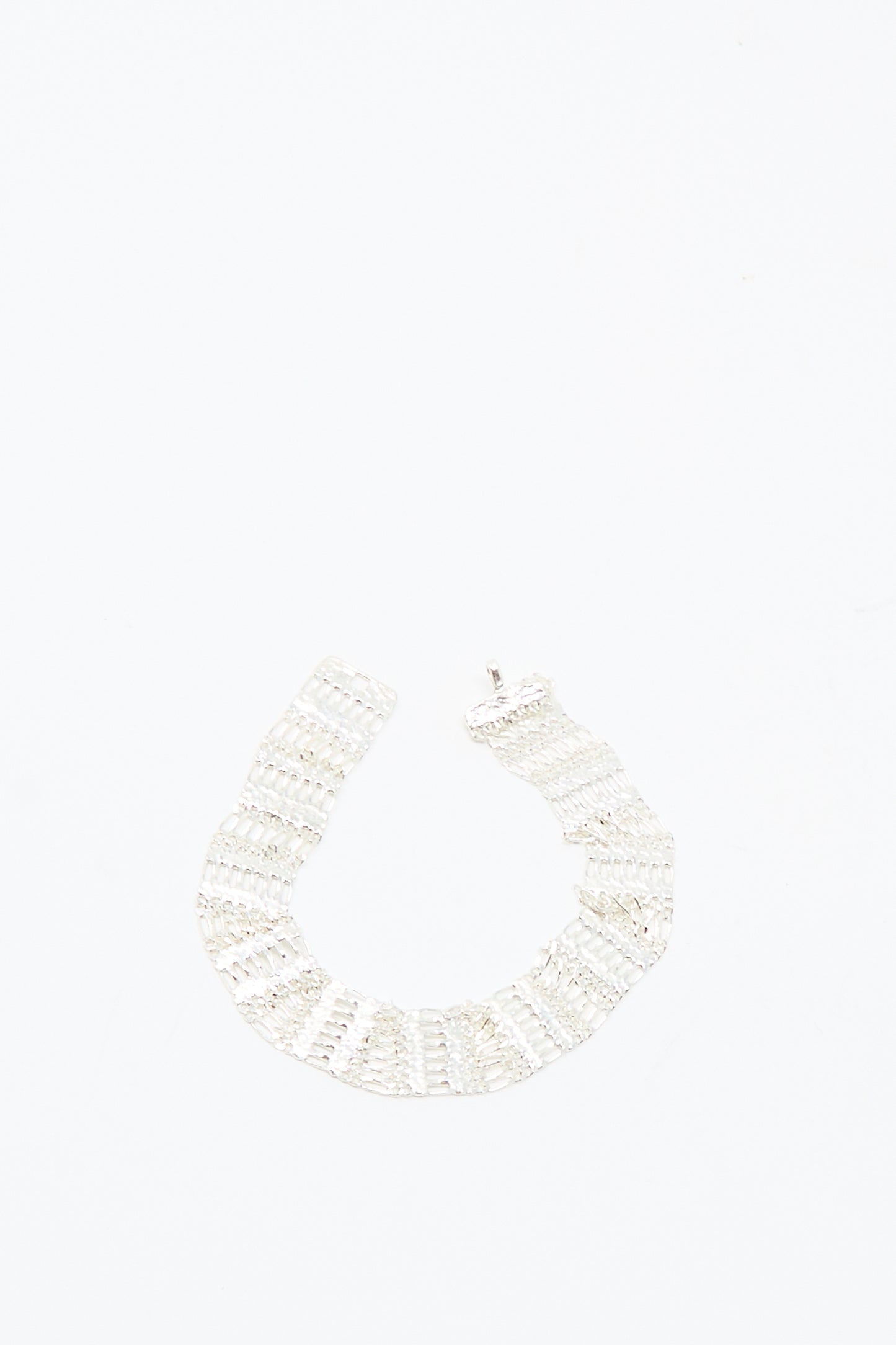 The Friendship Bracelet in Silver by Hannah Keefe, featuring a handmade sterling silver and wide segmented design, is showcased against a plain white background.
