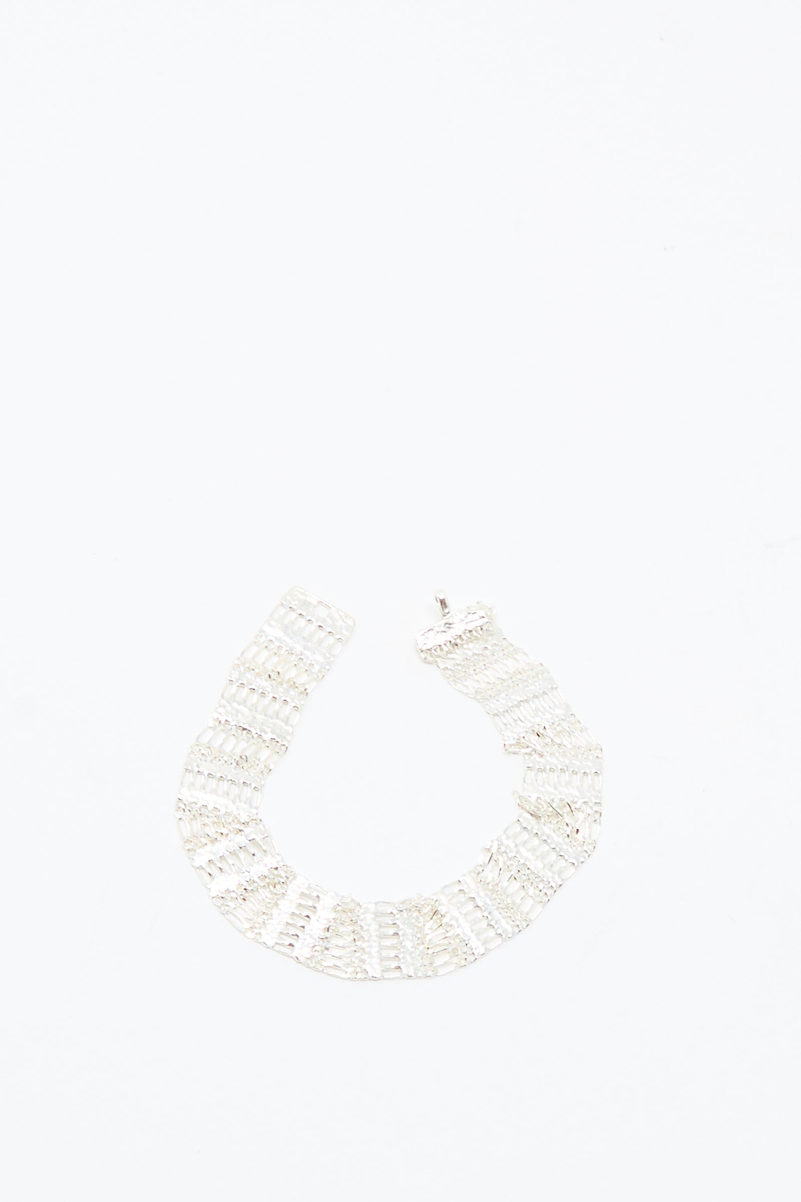 The Friendship Bracelet in Silver by Hannah Keefe, featuring a handmade sterling silver and wide segmented design, is showcased against a plain white background.