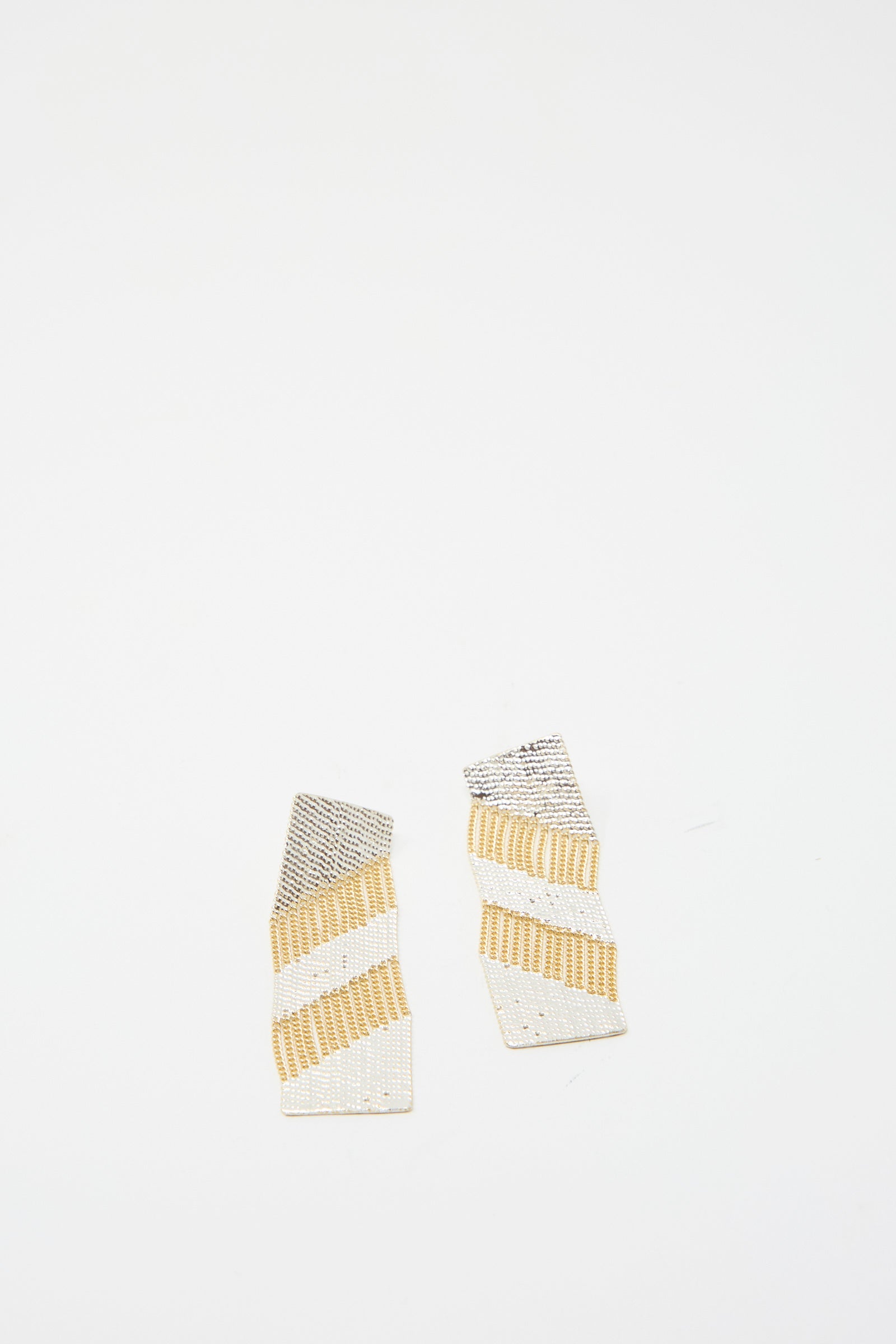 The Sunny Earrings in Brass and Silver, designed by Hannah Keefe, feature a striped pattern of brass and silver, displayed on a plain white background.