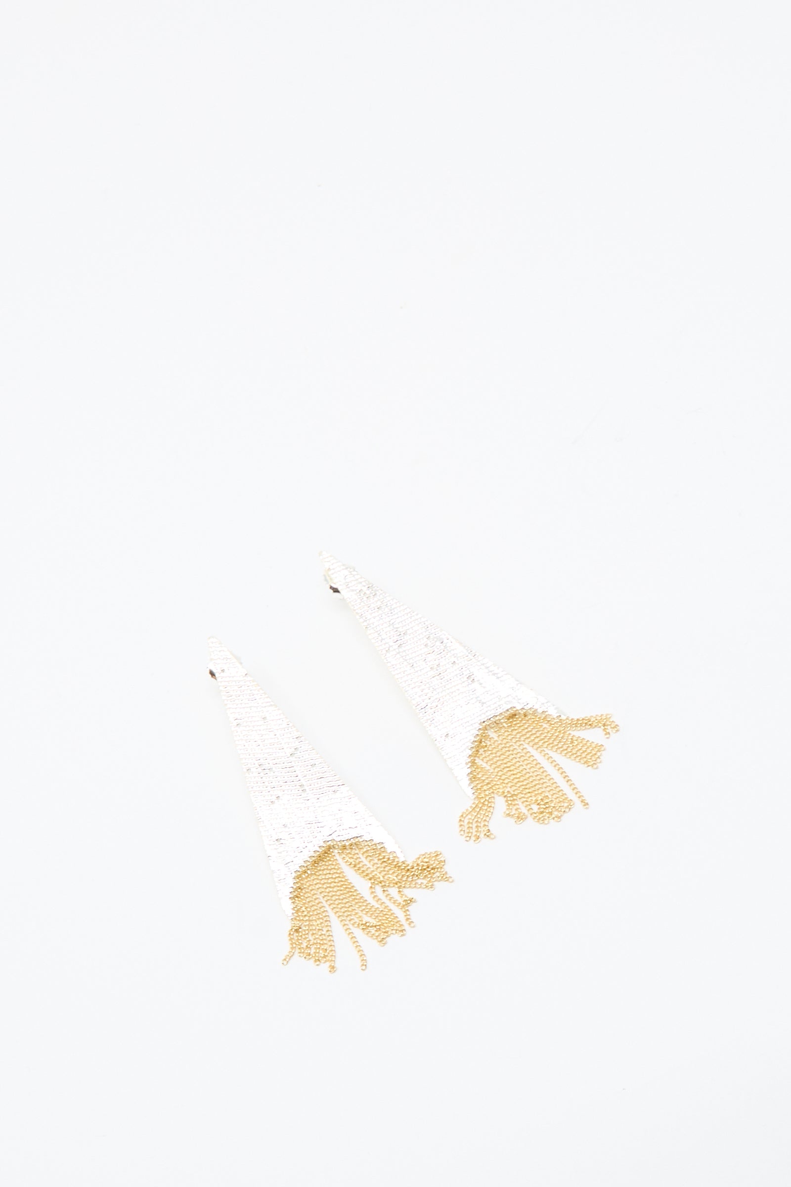 The Teardrop Earrings in Brass and Silver by Hannah Keefe feature a white, triangular design with silver brass fringe, handmade in California and shown on a plain white background.