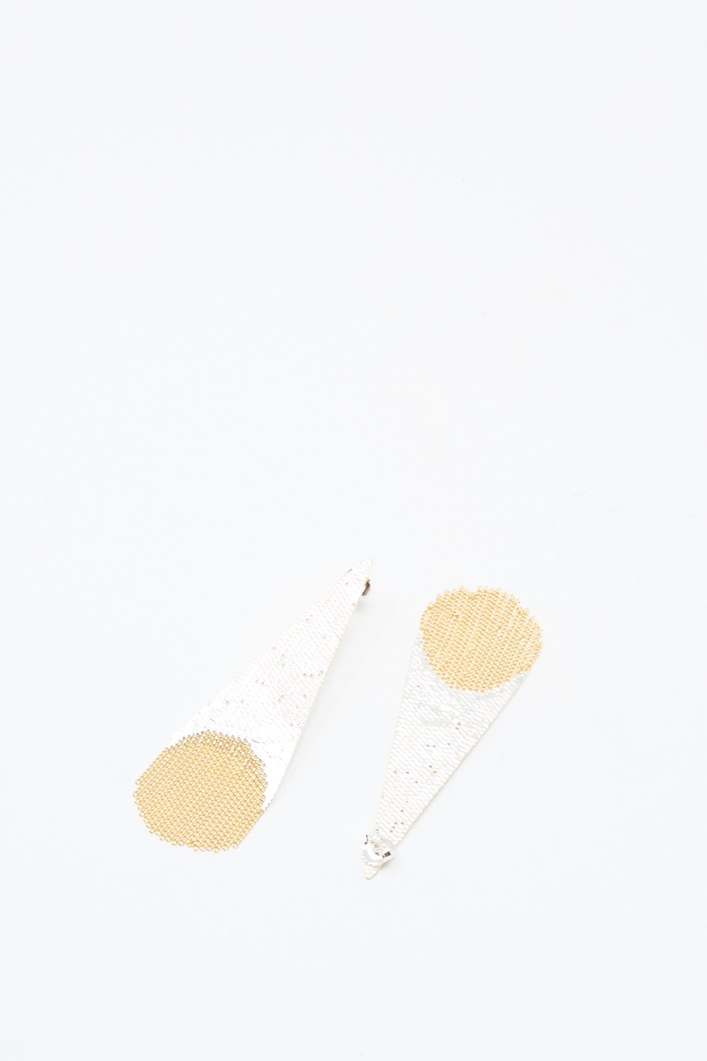 The Hannah Keefe Teardrop Earrings in Brass and Silver feature a geometric design with silver triangles, gold circular accents, and silver brass fringe—handmade in California.