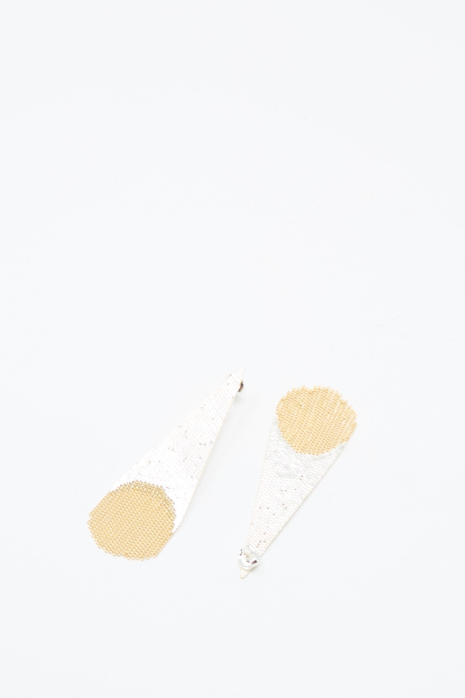 The Hannah Keefe Teardrop Earrings in Brass and Silver feature a geometric design with silver triangles, gold circular accents, and silver brass fringe—handmade in California.