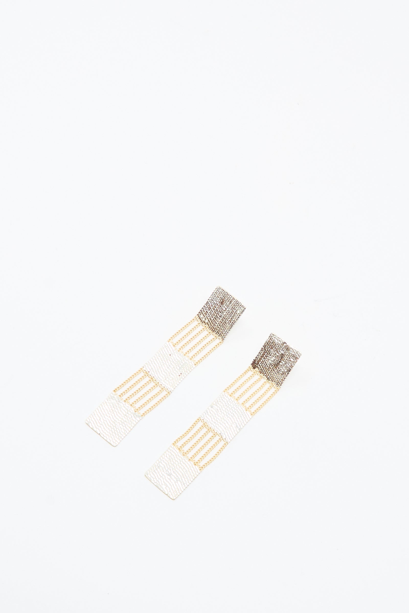 The Train Earrings in Brass and Silver by Hannah Keefe are rectangular drop earrings with alternating gold and silver striped segments, shown on a white background.