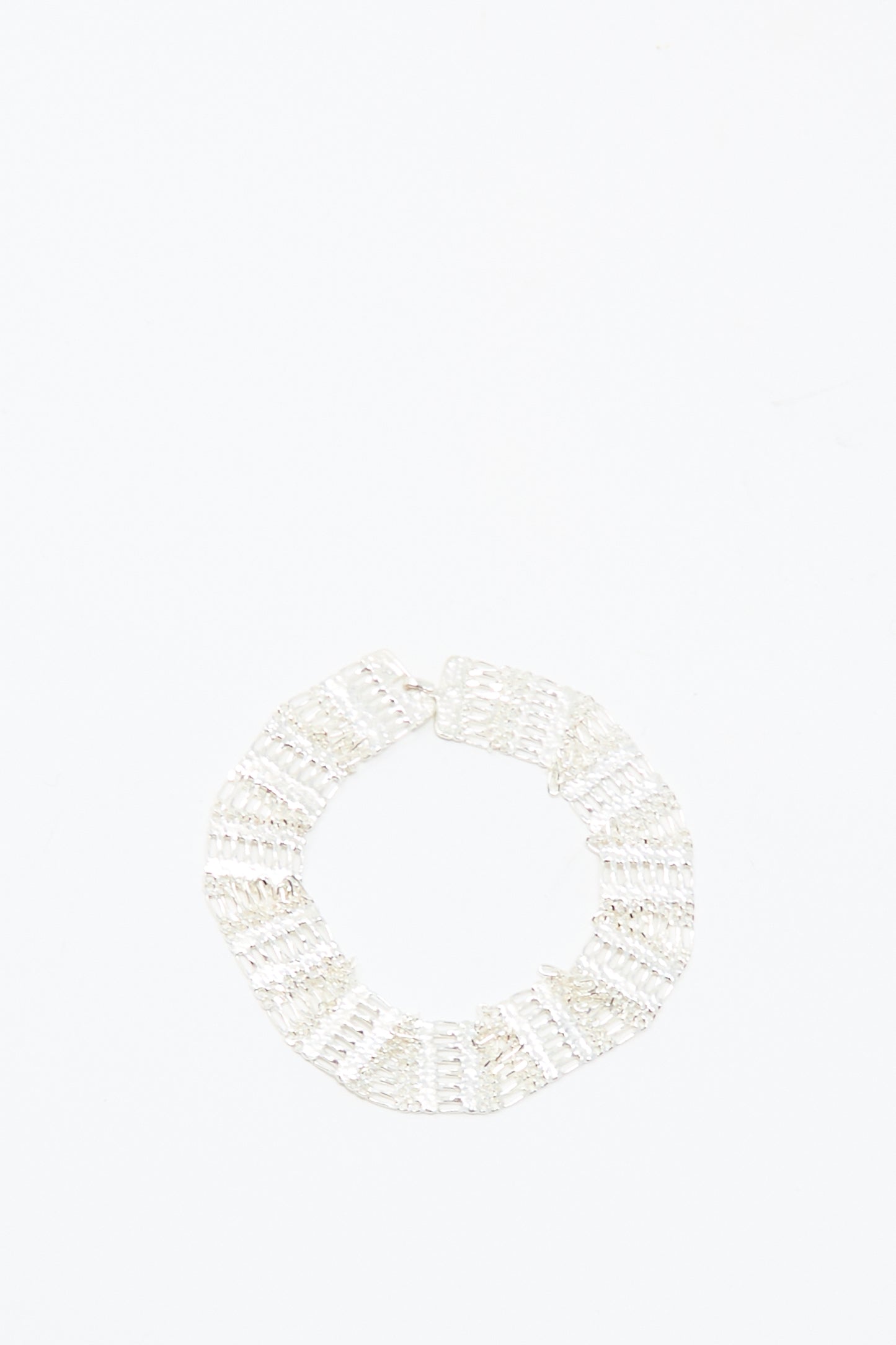The Friendship Bracelet in Silver by Hannah Keefe, a handmade sterling silver textured circle design, is displayed against a plain white background.