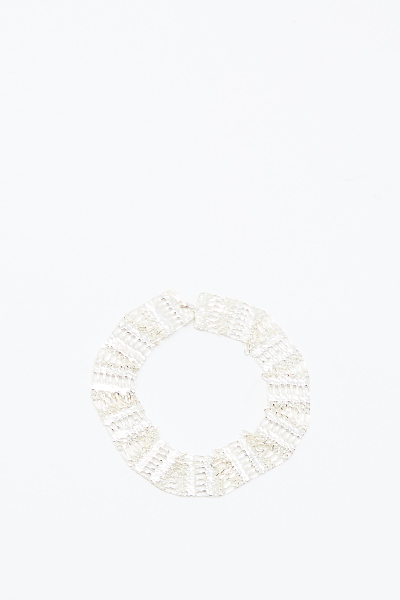 The Friendship Bracelet in Silver by Hannah Keefe, a handmade sterling silver textured circle design, is displayed against a plain white background.