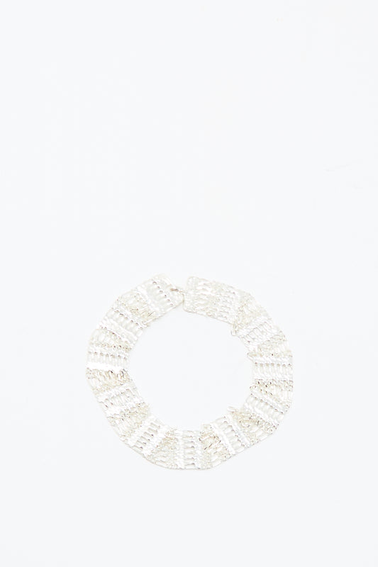 The Friendship Bracelet in Silver by Hannah Keefe, a handmade sterling silver textured circle design, is displayed against a plain white background.