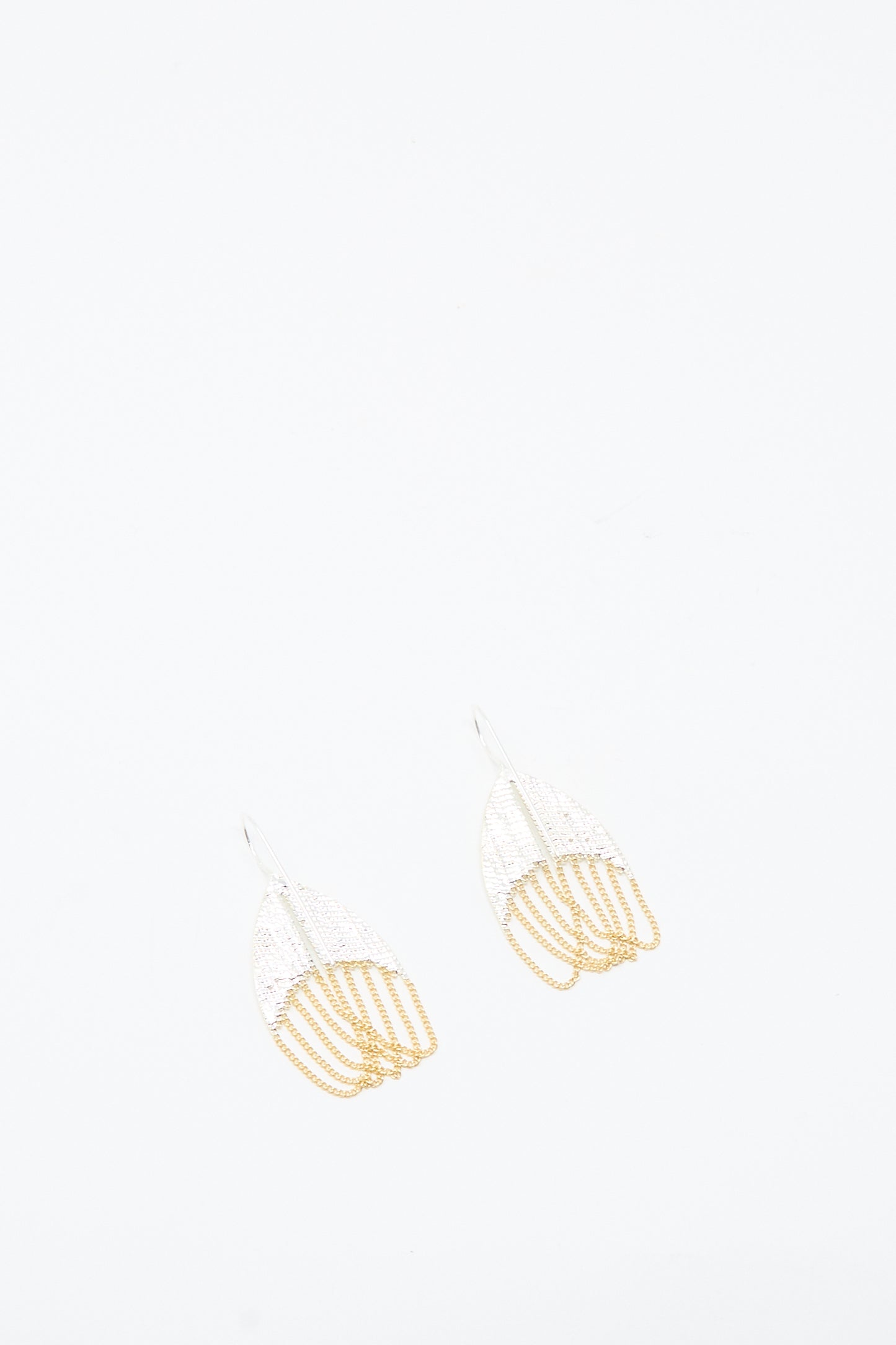 The Scarab Earrings in Brass and Silver by Hannah Keefe feature a delicate, abstract fan-like design shown on a plain white background.