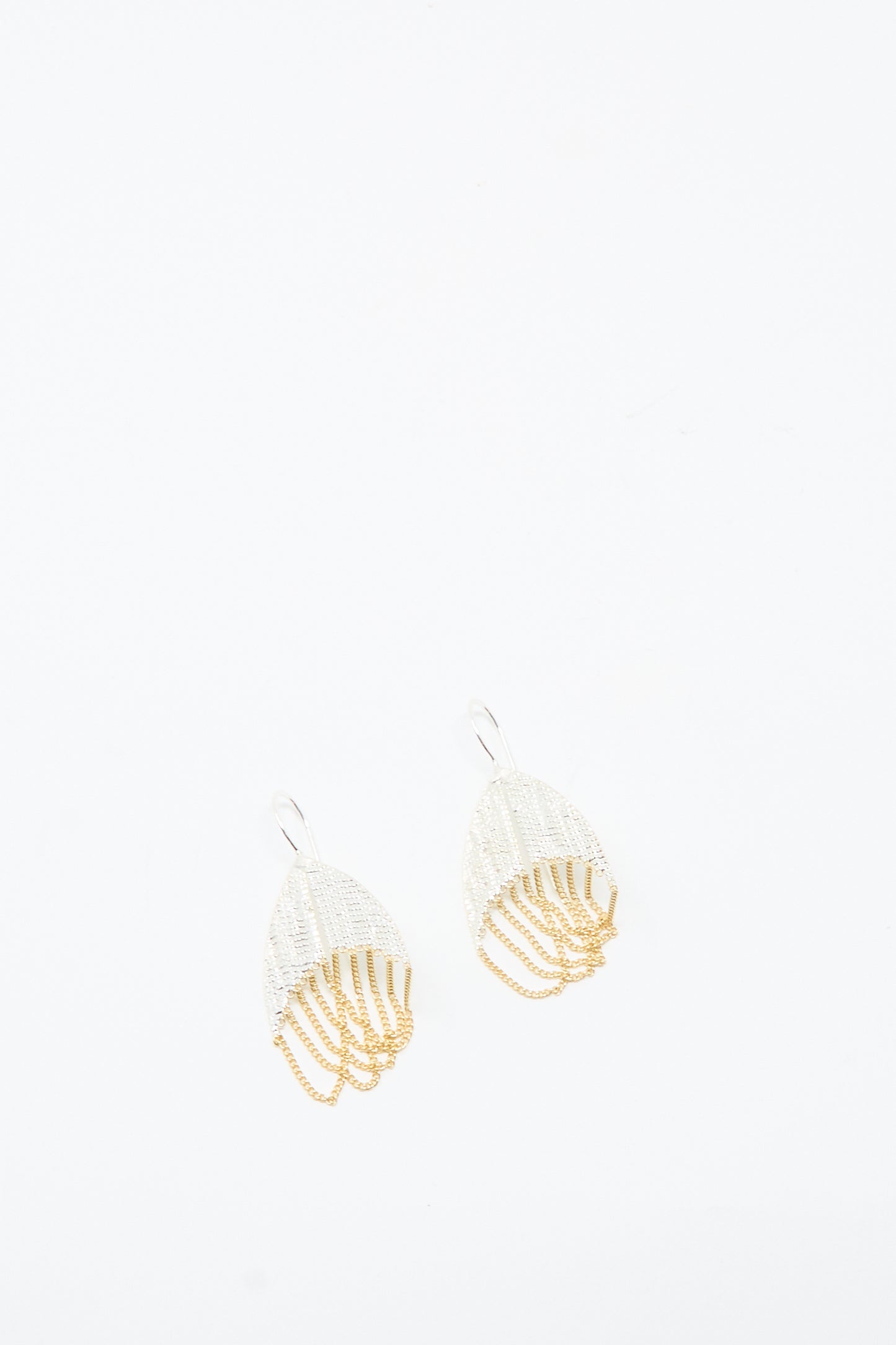 The Scarab Earrings in Brass and Silver by Hannah Keefe feature a handmade layered, fan-like design with delicate chains and hook backs, shown on a white background.