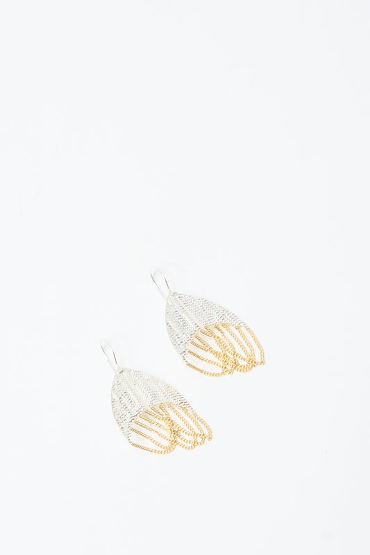 The Scarab Earrings in Brass and Silver by Hannah Keefe are handmade hook earrings with a silver upper and gold lower mesh-like, layered design, shown on a plain white background.
