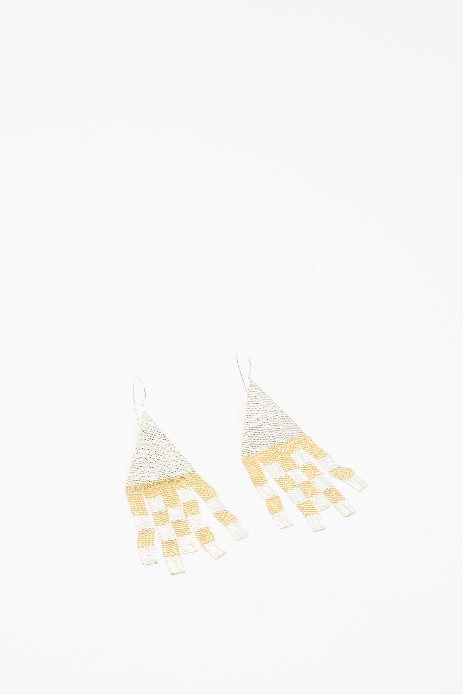 The Scotch Earrings in Brass and Silver by Hannah Keefe are handmade in California, featuring brass and silver checkerboard triangles with dangling rectangular fringe.