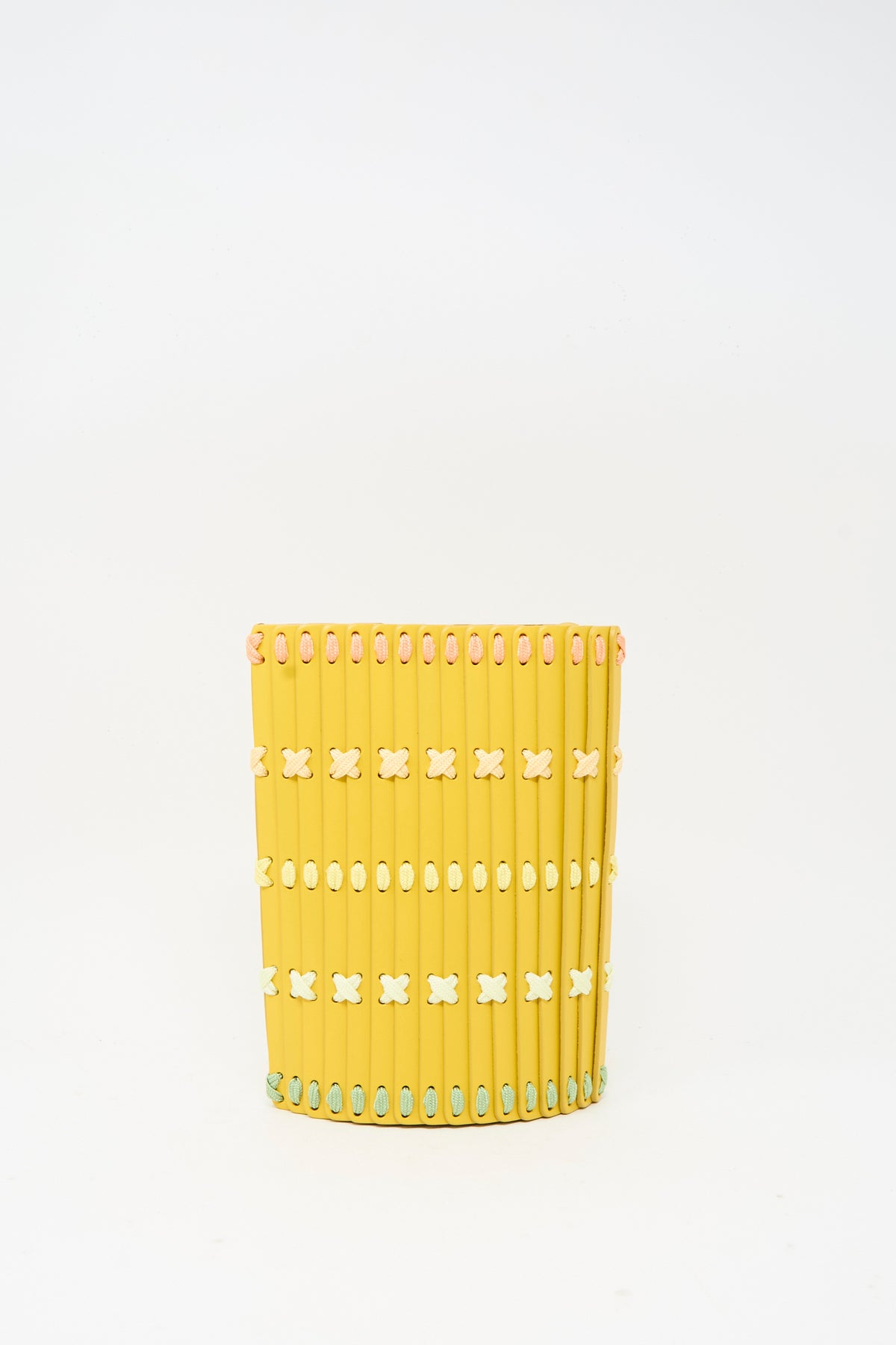 Yellow cylindrical Hatori Leather Crossbody 30 Artist Edition with Holly Coulis in Yellow, featuring vertical slats connected by light-colored woven stitching in X and circular patterns.