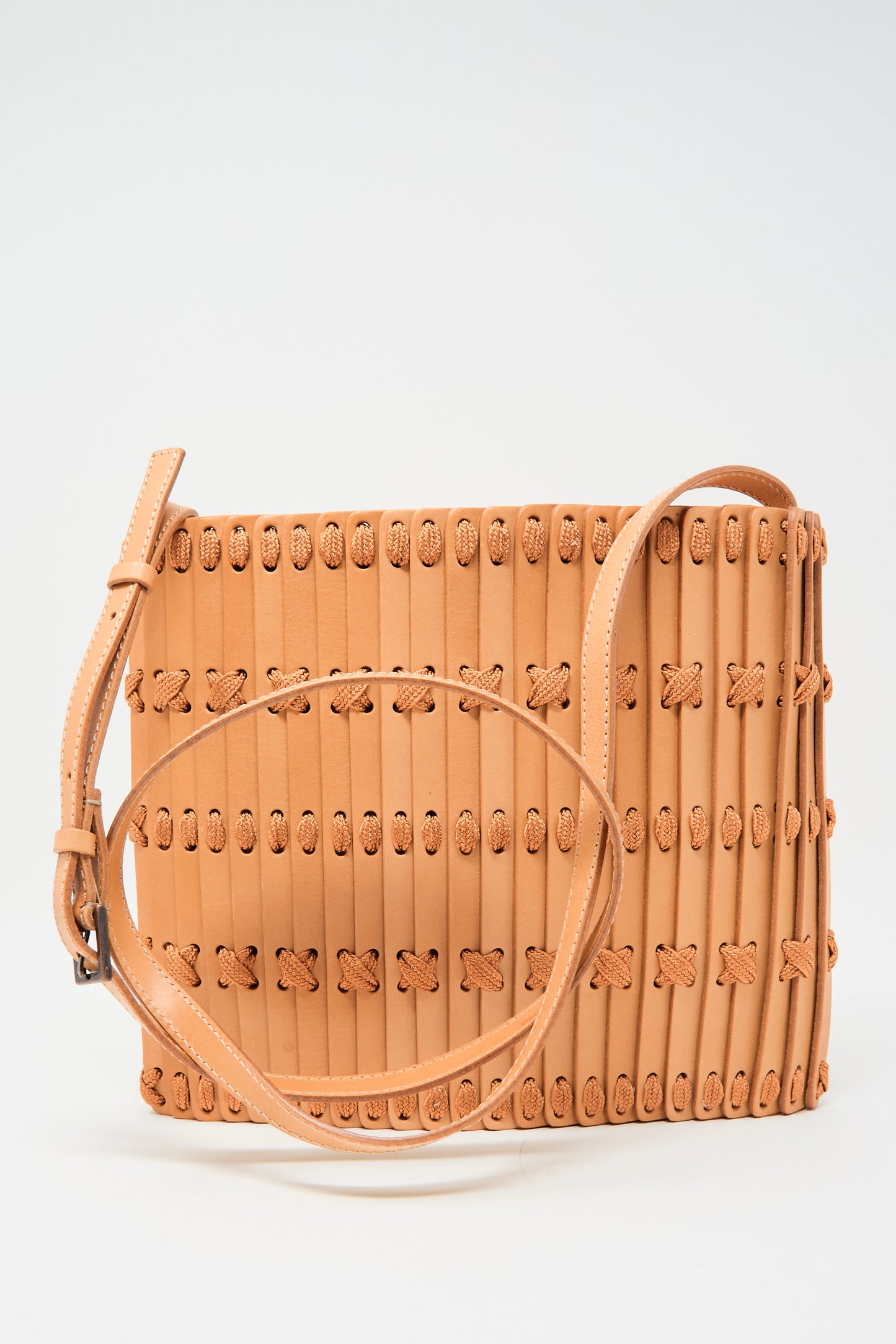 The Hatori Leather Crossbody 48 in Natural with Natural Lace features vertical strips, decorative stitching, and an adjustable shoulder strap, shown on a plain white background.