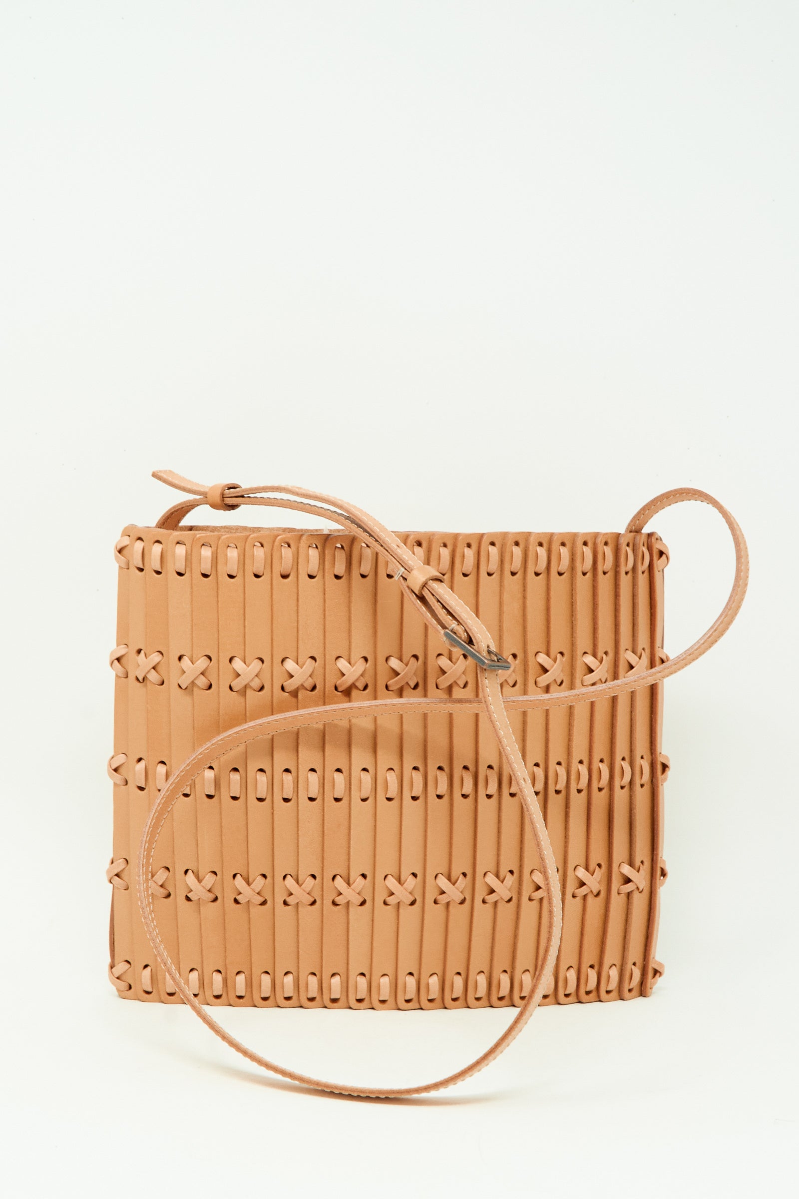 The Hatori Leather Crossbody 48 in Natural with Tanned Lace features a square design, woven stitched pattern, and long thin shoulder strap, handcrafted from vegetable tanned leather and shown against a plain white background.