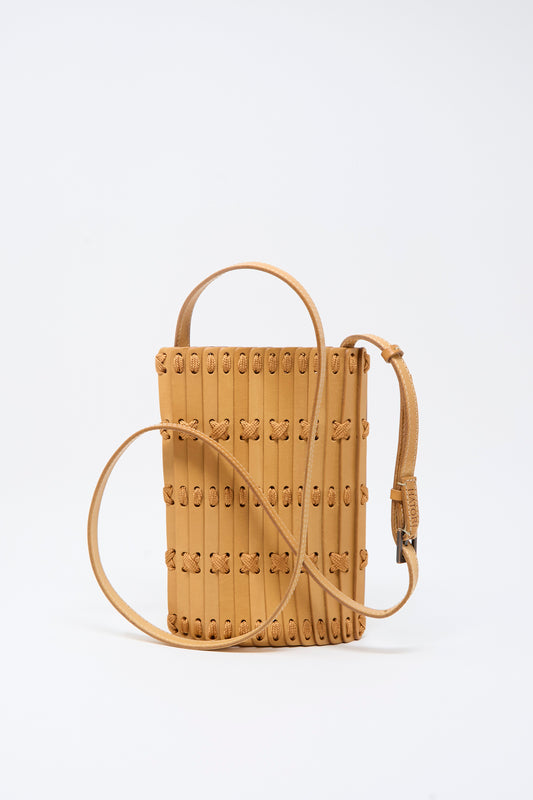 The Hatori Leather Phone 26 Bag in Natural with Tan Lacing is a handcrafted rectangular crossbody featuring vertical stitching, looped lacing accents, a top handle, and an adjustable shoulder strap—expertly made from premium vegetable-tanned leather and shown against a plain white background.