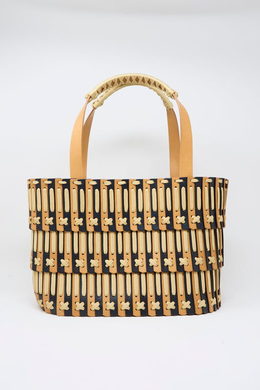 The Hatori Leather Tote 198 in Bi-Color with Tan Lacing features tan handles and layered black, beige, and tan patterned bands. Handcrafted in Tokyo, it is displayed against a plain white background.